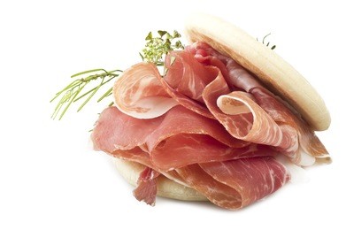 italian prosciutto crudo ,raw ham leg sliced on white