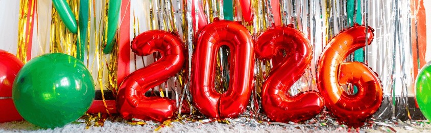 red foil balloons forming number 2026 with colorful party decorations. celebration scene likely for new year or milestone event.