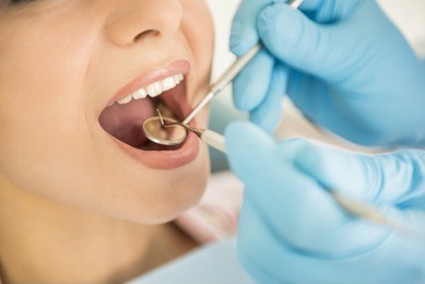 dentist examining a patient's teeth in the dentist.