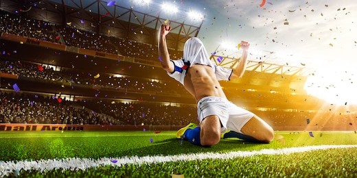 soccer player in action on night stadium panorama background