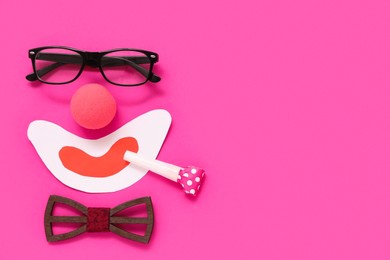 funny clown's face made of glasses, ball and bow tie on pink background