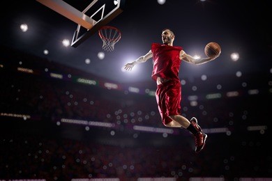 red basketball player in action in gym