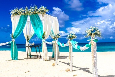 beach wedding venue, wedding setup, cabana, arch, gazebo decorated with flowers
