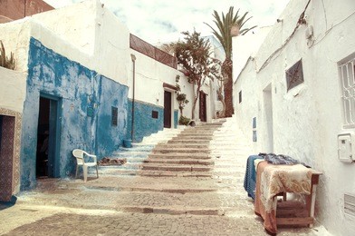 famous blue and white streets of kasbah of the udayas in rabat. the capital of morocco has unesco world heritage status and very famous among tourists. vintage look - faded colors
