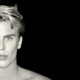 beauty skincare and haircare concept. handsome young man on black background. perfect skin. man half face portrait