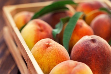 fresh peaches in a wooden basket