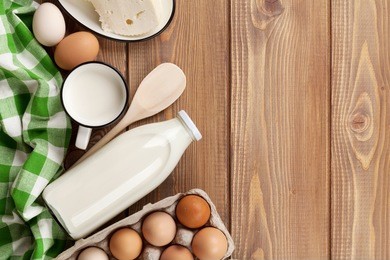 dairy products on wooden table. milk, cheese and eggs. top view with copy space