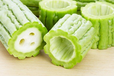 bitter gourd slices on wooden in white background
