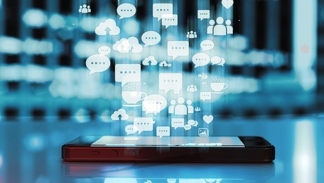 black smart phone emitting blue holographic images of social media related icons. 