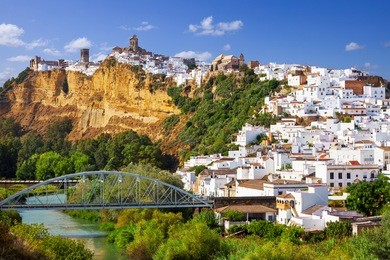 panoramic of arcos de la frontera, white town built on a rock along guadalete river, in the province of cadiz, spain