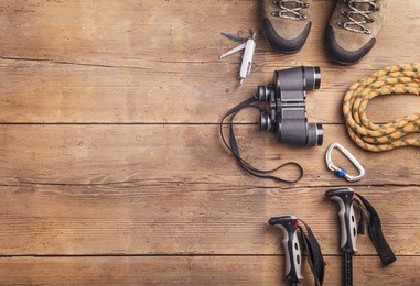 equipment for hiking on a wooden floor background