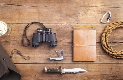 equipment for hiking on a wooden floor background
