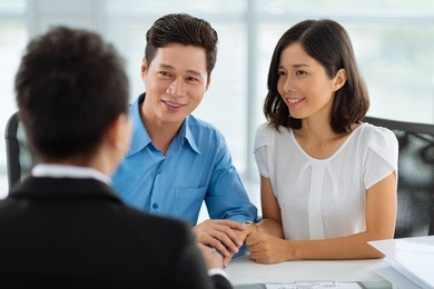 asian married couple at the meeting with real estate agent