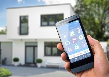 smart house, home automation, device with app icons. man uses his smart phone with smarthome security app to unlock the door of his house.