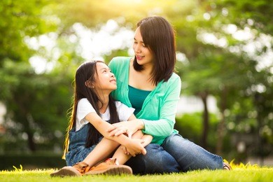 happy young mother with her daughter at park