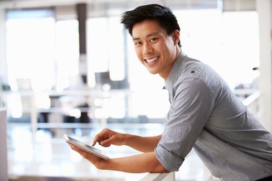 portrait of young man using tablet in office