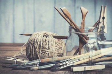vintage artists tools on rustic wooden background. 