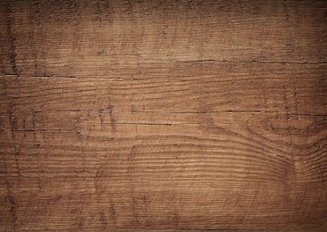 dark brown scratched wooden cutting board. wood texture