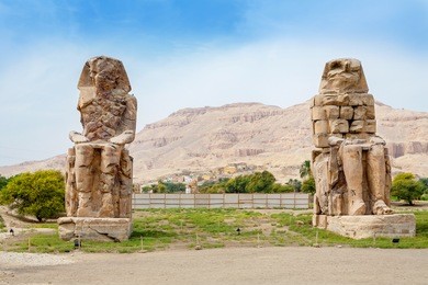 the colossi of memnon are two giant stone statues of pharaoh amenhotep iii. luxor, west bank, egypt
