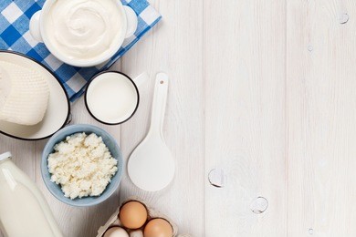 dairy products on wooden table. sour cream, milk, cheese, eggs and yogurt. top view with copy space