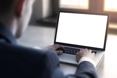 businessman using laptop with blank screen.