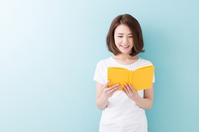 young attractive asian woman who reads a book