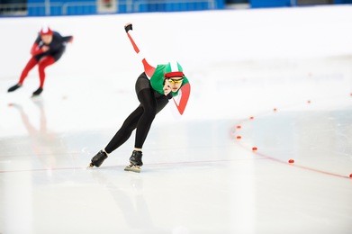 speed skating young female sportsman during competition race 