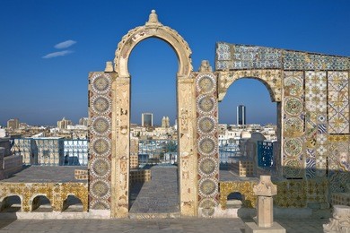 tunisia. tunis - old town (medina) seen from roof top. ornamental arches and wall covered tiles with geometric shape motifs