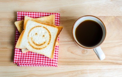 coffee and toasts on wooden table