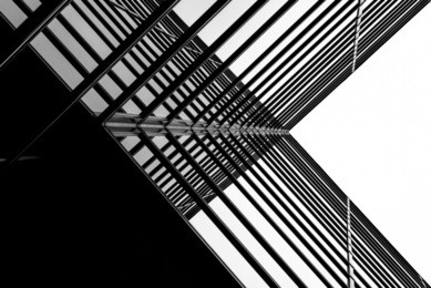 urban geometry, looking up to glass building. modern architecture black and white, glass and steel. x marks the spot. abstract architectural design. inspirational, artistic image bw.