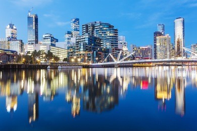 cityspace of dockland in melbourne at sunset with reflection