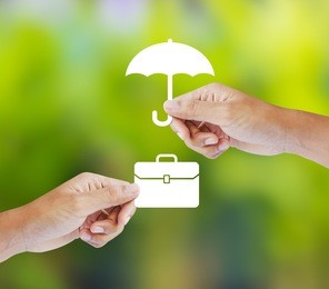 business insurance concept with an umbrella covering business briefcase