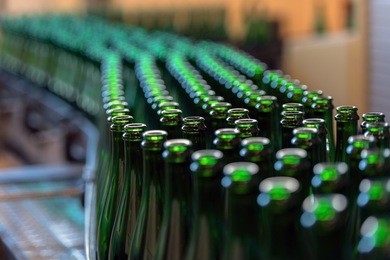 many bottles on conveyor belt in factory