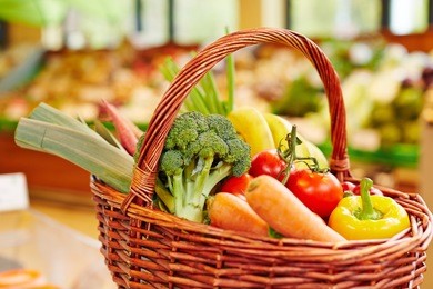 colorful fresh vegetables in a shopping basket in a supermarket