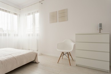simple exclusive white bedroom with wooden parquet 