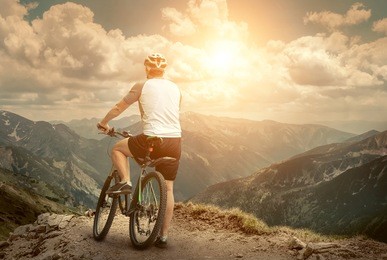 men with bicycle aroun mountains beautiful view.