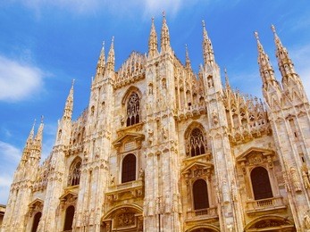 vintage looking duomo di milano meaning milan cathedral in italy, with blue sky