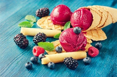 purple ice cream with waffles and berries, sorbet, healthy dessert rustic ice cones