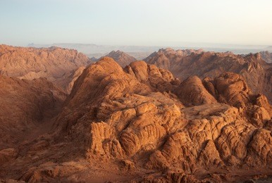panorama rocks of holy ground mount sinai in early morning "and the mountains shall be molten under him, and the valleys shall be cleft, as wax before the fire..." micah 1:4
