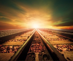 junction of railways track in trains station against beautiful light of sun set sky use for land transport and logistic industry background ,backdrop,copy space theme