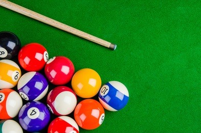 billiard balls on green table with billiard cue, snooker, pool game.