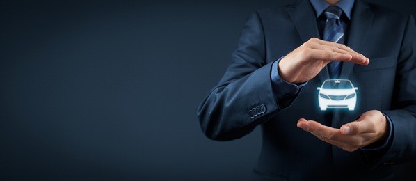 car (automobile) insurance and collision damage waiver concepts. businessman with protective gesture and icon of car. 