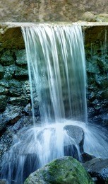 small stream flows on stones photographed close up