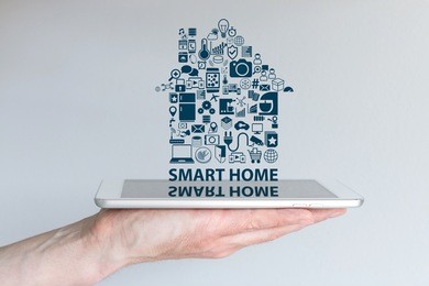 smart home automation concept. background with hand holding smart phone and floating text and icons. reflections on screen.