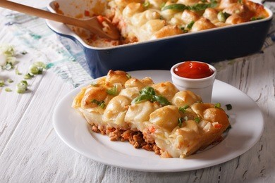 shepherds pie slice closeup on a white plate. horizontal