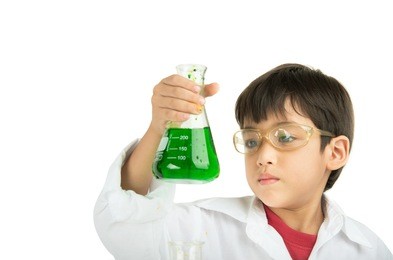 little boy learning in chemical in science in class