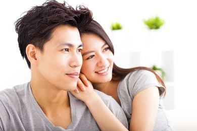 young happy couple hugging and looking