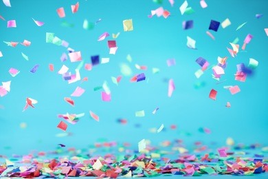 colored confetti flying on blue background