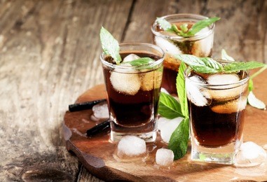 cold drink with cola, ice and mint, selective focus