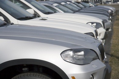 row of brand new cars at dealership lot